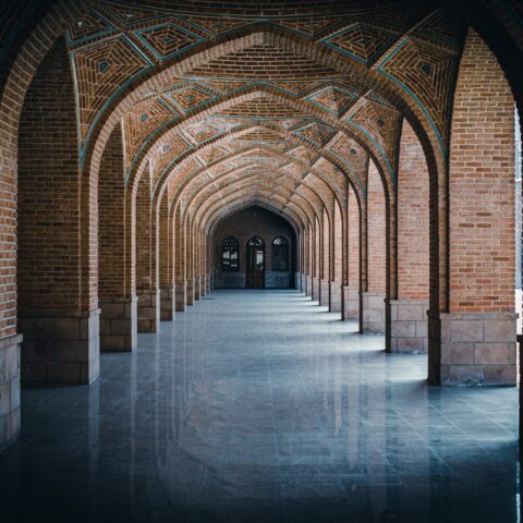 person in black jacket standing on gray concrete floor