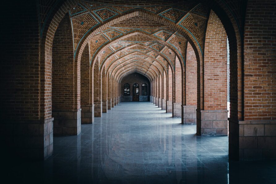person in black jacket standing on gray concrete floor