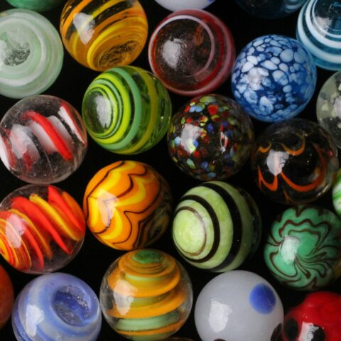 a bunch of different colored marbles sitting on top of each other